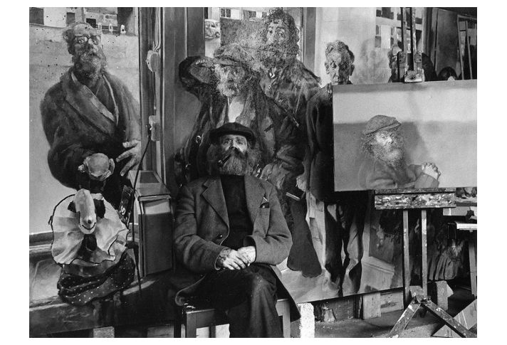 Diogenes seated with some of his portraits, 1974. (Photo: Ivor J. Hibbard)